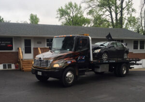 Parking Enforcement Prince George's County Maryland J & L Towing Flatbed Tow Truck Parked In Front of business