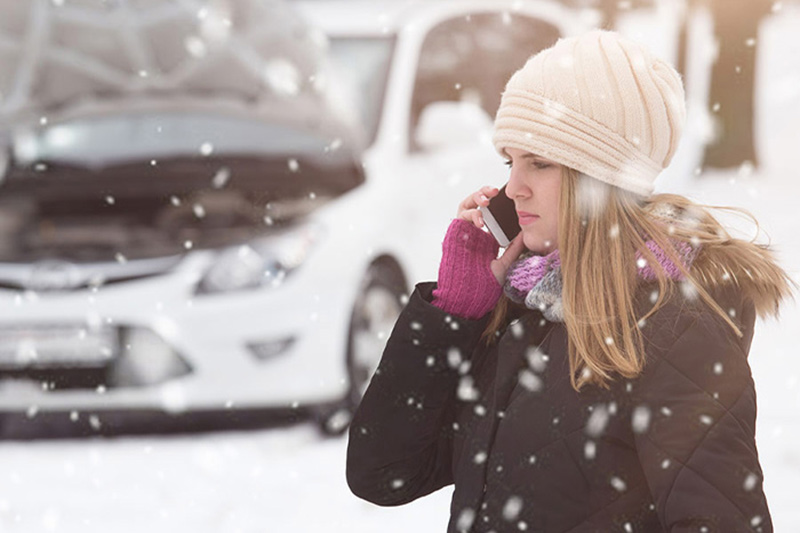 Snow emergency towing service woman calling for help in snow storm Upper Marlboro