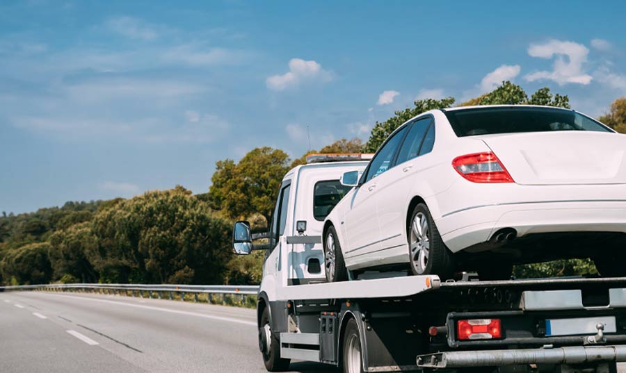 Car-loaded-on-flatbed-tow-truck-for-a-long-distance-move Car loaded on J & L Towing flatbed tow truck for long distance tow out of Marlboro Maryland